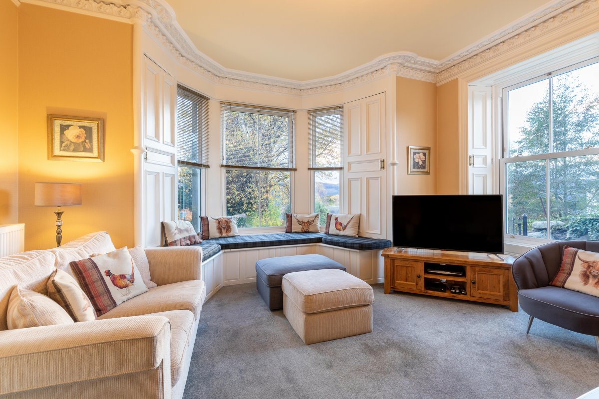 The lounge with bay window seat overlooking the garden